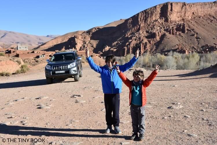 On the road to the desert, car and two kids, Morocco.