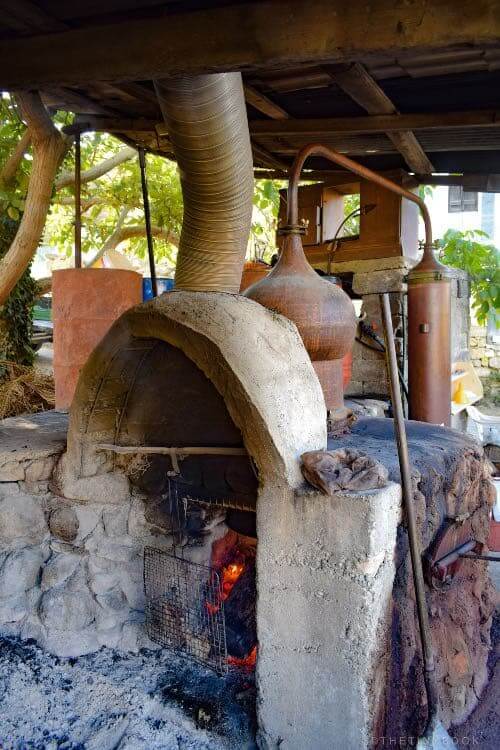 Crete Travel Blog: Essential Things to Know about Cretan Raki (Tsikoudia) 10 cretan raki heating the caultron of raki