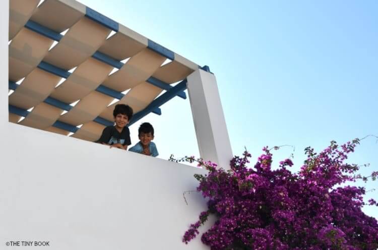 Kids in balcony, Kouros Village, Antipaso island, Greece.