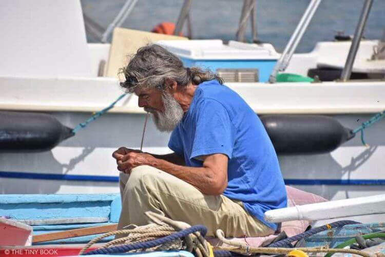 Sailor repairing net in Greece