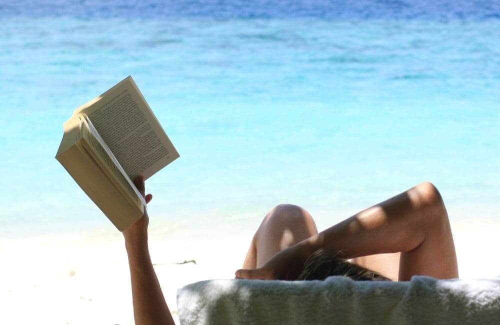 READING A BOOK AT THE BEACH