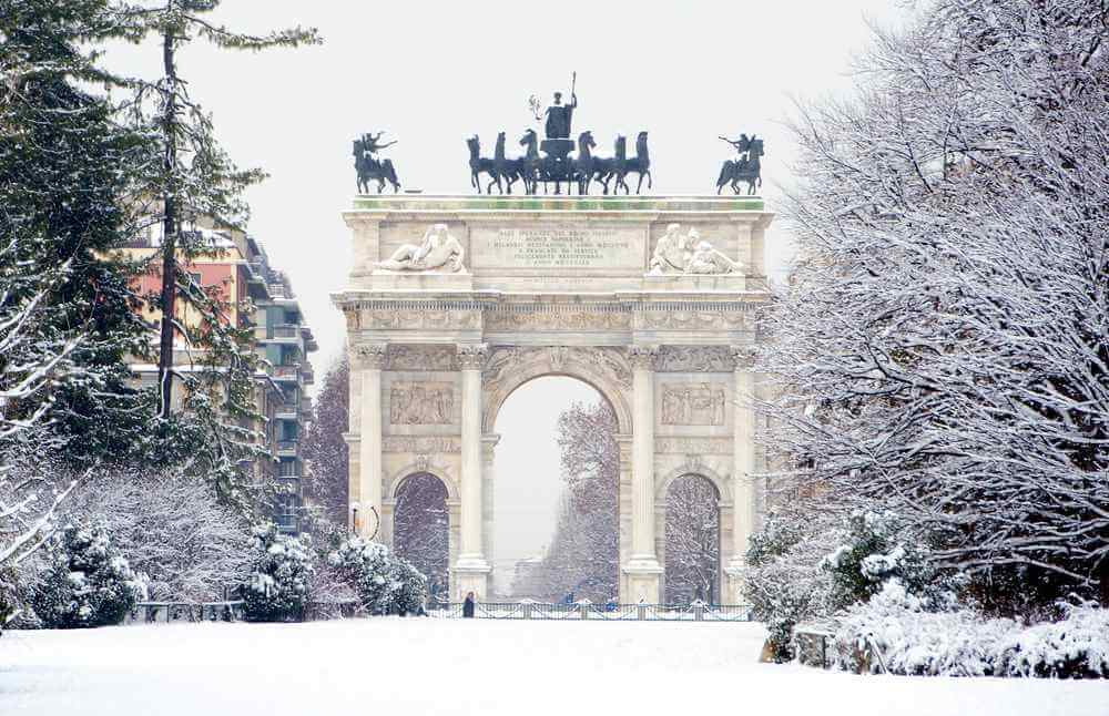 Peace Arch covered with snow in Sempione park, Milan, Italy.