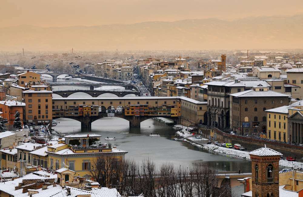 Florence in Winter: Ponte Vecchio or Old Bridge Florence Italy with snow panorama Tuscany